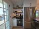 Kitchenette with beverage cooler, stainless steel refrigerator, wood shelving and lots of natural light at 2946 E Flower St, Phoenix, AZ 85016