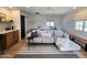 Bright living room featuring a sleek sectional sofa, stylish rug, and a glimpse of the modern bedroom area at 2946 E Flower St, Phoenix, AZ 85016