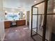 Main bathroom boasts wood vanity with marble countertop, modern lighting fixtures, and glass enclosed shower at 2946 E Flower St, Phoenix, AZ 85016