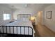 Main bedroom features a ceiling fan, modern light fixtures, white walls and neutral toned carpet at 2946 E Flower St, Phoenix, AZ 85016