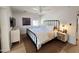 Main bedroom with hardwood floors, ceiling fan, modern light fixtures and an accent rug at 2946 E Flower St, Phoenix, AZ 85016