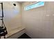 Modern walk-in shower featuring stylish tile, a comfortable bench, a rain shower head and a bright window at 2946 E Flower St, Phoenix, AZ 85016