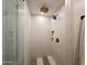 Sleek shower area with white tiles, bronze fixtures, and a modern design at 2946 E Flower St, Phoenix, AZ 85016