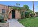 Charming brick home with arched doorway and lush greenery creating a welcoming entrance at 3036 N 32Nd St # 314, Phoenix, AZ 85018