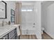 A bright bathroom featuring a shower-tub combination, modern sink, and contemporary decor at 3050 S Cascade Pl, Chandler, AZ 85248