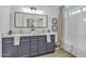 Beautiful bathroom with double sink vanity, modern light fixture, and shower-tub combination at 3050 S Cascade Pl, Chandler, AZ 85248