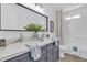 Bright bathroom boasts a double sink vanity with granite countertop, framed mirror and shower over tub at 3050 S Cascade Pl, Chandler, AZ 85248