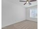 Bright bedroom features plush carpeting, a modern ceiling fan, and a large window for natural light at 3050 S Cascade Pl, Chandler, AZ 85248