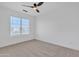 An empty bedroom that features wall to wall carpetting with a ceiling fan, a window, and is freshly painted at 3050 S Cascade Pl, Chandler, AZ 85248