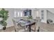 Cozy dining room featuring a modern table set for four and views to the white-walled kitchen at 3050 S Cascade Pl, Chandler, AZ 85248