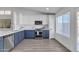 Bright kitchen featuring stainless steel appliances, a window, and a combination of white and blue cabinets at 3050 S Cascade Pl, Chandler, AZ 85248