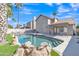 Backyard features a private pool with a waterfall feature, lush landscaping and outdoor living at 3050 S Cascade Pl, Chandler, AZ 85248