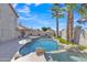 Backyard features a private pool with a waterfall feature, and palm trees at 3050 S Cascade Pl, Chandler, AZ 85248