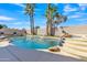 Inviting backyard pool with a rock waterfall feature, surrounded by desert landscaping at 3050 S Cascade Pl, Chandler, AZ 85248