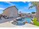 Backyard features a private pool with a waterfall feature, lush landscaping and outdoor living at 3050 S Cascade Pl, Chandler, AZ 85248