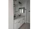 Bathroom featuring double sinks, white cabinetry, and modern fixtures at 31487 N Blackfoot Dr, San Tan Valley, AZ 85143