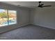 Bedroom with gray carpet overlooking a pool with water feature at 31487 N Blackfoot Dr, San Tan Valley, AZ 85143