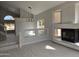 Bright and airy living room featuring a fireplace, staircase, and vaulted ceiling at 31487 N Blackfoot Dr, San Tan Valley, AZ 85143