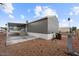 Side view of home with a covered patio and rock landscaping at 320 E Mckellips Rd # 227, Mesa, AZ 85201