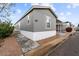 Home exterior with muted gray siding, modern windows, and trimmed landscaping at 320 E Mckellips Rd # 227, Mesa, AZ 85201