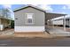 Exterior view of a single-story home with neutral siding and a covered parking area at 320 E Mckellips Rd # 227, Mesa, AZ 85201