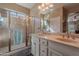 Well-lit bathroom with double sinks, a clear glass shower and ample counter space at 336 N Monterey Ct, Casa Grande, AZ 85194