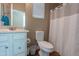 Clean bathroom with a white vanity, toilet, and shower with a white curtain at 336 N Monterey Ct, Casa Grande, AZ 85194