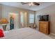 Comfortable bedroom with a view of a walk-in closet and a wooden dresser with TV at 336 N Monterey Ct, Casa Grande, AZ 85194