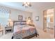 Cozy bedroom with a decorative bedspread, ceiling fan, and bedside lamps with an ensuite bathroom at 336 N Monterey Ct, Casa Grande, AZ 85194