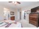 Bedroom featuring a ceiling fan and an open closet and bathroom adding convenience and functionality to the home at 336 N Monterey Ct, Casa Grande, AZ 85194