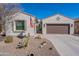 Charming home featuring desert landscaping, a secure gate, and a brown two-car garage, with an American flag displayed at 336 N Monterey Ct, Casa Grande, AZ 85194