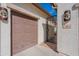 Close-up of the two-car garage, featuring unique lighting fixtures and decorative gate at the home's entrance at 336 N Monterey Ct, Casa Grande, AZ 85194