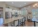 Bright kitchen featuring stainless steel appliances, a granite island, and white cabinetry at 336 N Monterey Ct, Casa Grande, AZ 85194