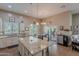 Open kitchen layout flowing into a dining area, with stainless steel appliances and a granite island at 336 N Monterey Ct, Casa Grande, AZ 85194