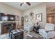 Spacious living room with white leather recliners and a large television at 336 N Monterey Ct, Casa Grande, AZ 85194