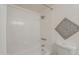 All-white bathroom features a shower with tiled walls and decor at 3420 W Danbury Dr # C216, Phoenix, AZ 85053