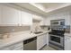 Modern kitchen showcases stainless steel appliances, subway tile backsplash, and white cabinetry at 3420 W Danbury Dr # C216, Phoenix, AZ 85053