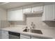 Kitchen with stainless steel sink, dishwasher, and modern countertops at 3420 W Danbury Dr # C216, Phoenix, AZ 85053