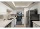 Modern kitchen with stainless steel appliances, white cabinets, and sleek countertops offering a functional cooking space at 3420 W Danbury Dr # C216, Phoenix, AZ 85053