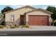 Charming single-story home featuring a two-car garage, stone accents, and drought-tolerant landscaping at 3508 E Audrey Dr, San Tan Valley, AZ 85143