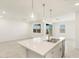 Bright kitchen with white island, modern stainless steel appliances, tile floors, and pendant lights at 3508 E Audrey Dr, San Tan Valley, AZ 85143