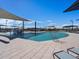 Large community pool with splash pad, sun shades, metal railing, lounge seating, and clear blue sky overhead at 3508 E Audrey Dr, San Tan Valley, AZ 85143