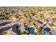 An aerial view of a neighborhood featuring a swimming pool, palm trees, and a well-maintained landscape at 3531 E Becker Ln, Phoenix, AZ 85028