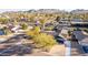 Aerial view showcases the home with its pool, mature landscaping, and mountain backdrop at 3531 E Becker Ln, Phoenix, AZ 85028