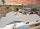 Aerial view of the home's roof, pool, and surrounding neighborhood with vibrant sunset at 3531 E Becker Ln, Phoenix, AZ 85028