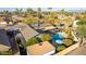 Birds-eye view of a private backyard with a pool, lush landscaping, patio cover, and meticulous landscaping at 3531 E Becker Ln, Phoenix, AZ 85028