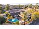 Aerial view of a backyard featuring a refreshing pool, patio area, mature trees, and stylish patio furniture at 3531 E Becker Ln, Phoenix, AZ 85028