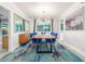 Dining room with blue chairs, modern chandelier, and stylish rug creating an elegant atmosphere at 3531 E Becker Ln, Phoenix, AZ 85028