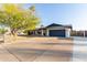 Well-maintained single-story home with blue garage door and tidy landscaping at 3531 E Becker Ln, Phoenix, AZ 85028