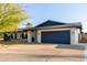 Well-maintained single-story home with blue garage door and tidy landscaping at 3531 E Becker Ln, Phoenix, AZ 85028